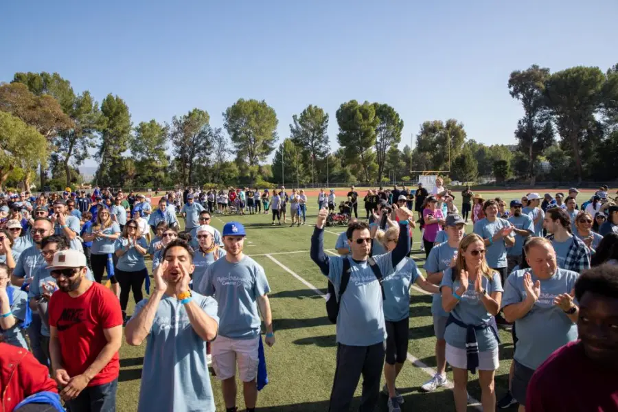 A crowd of ASC walkers on a stadium field