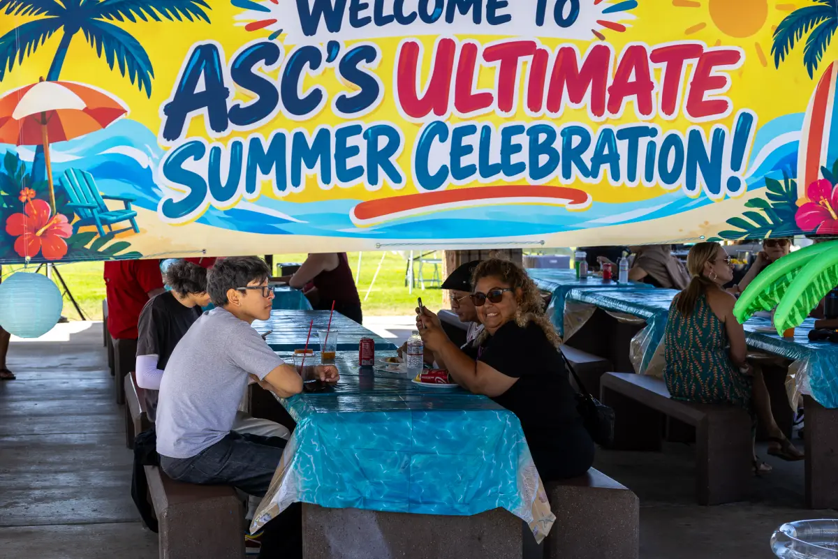 The ASC's Ultimate Summer Celebration banner over picnic tables