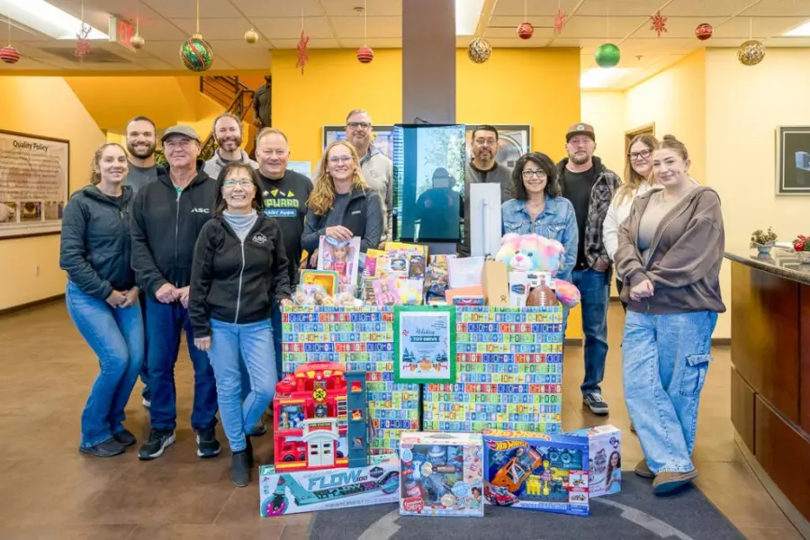 ASC employees with a mountain of donated toys