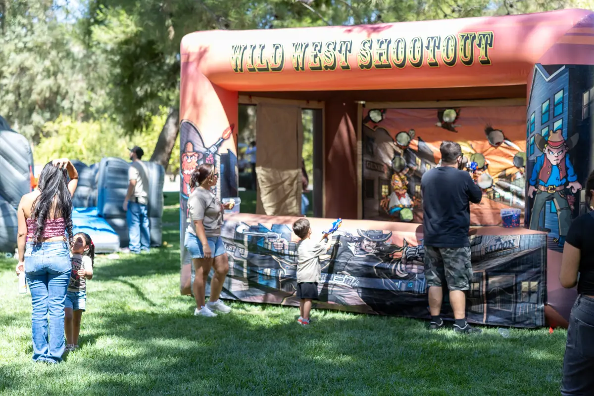 Families at the Wild West Shootout game booth