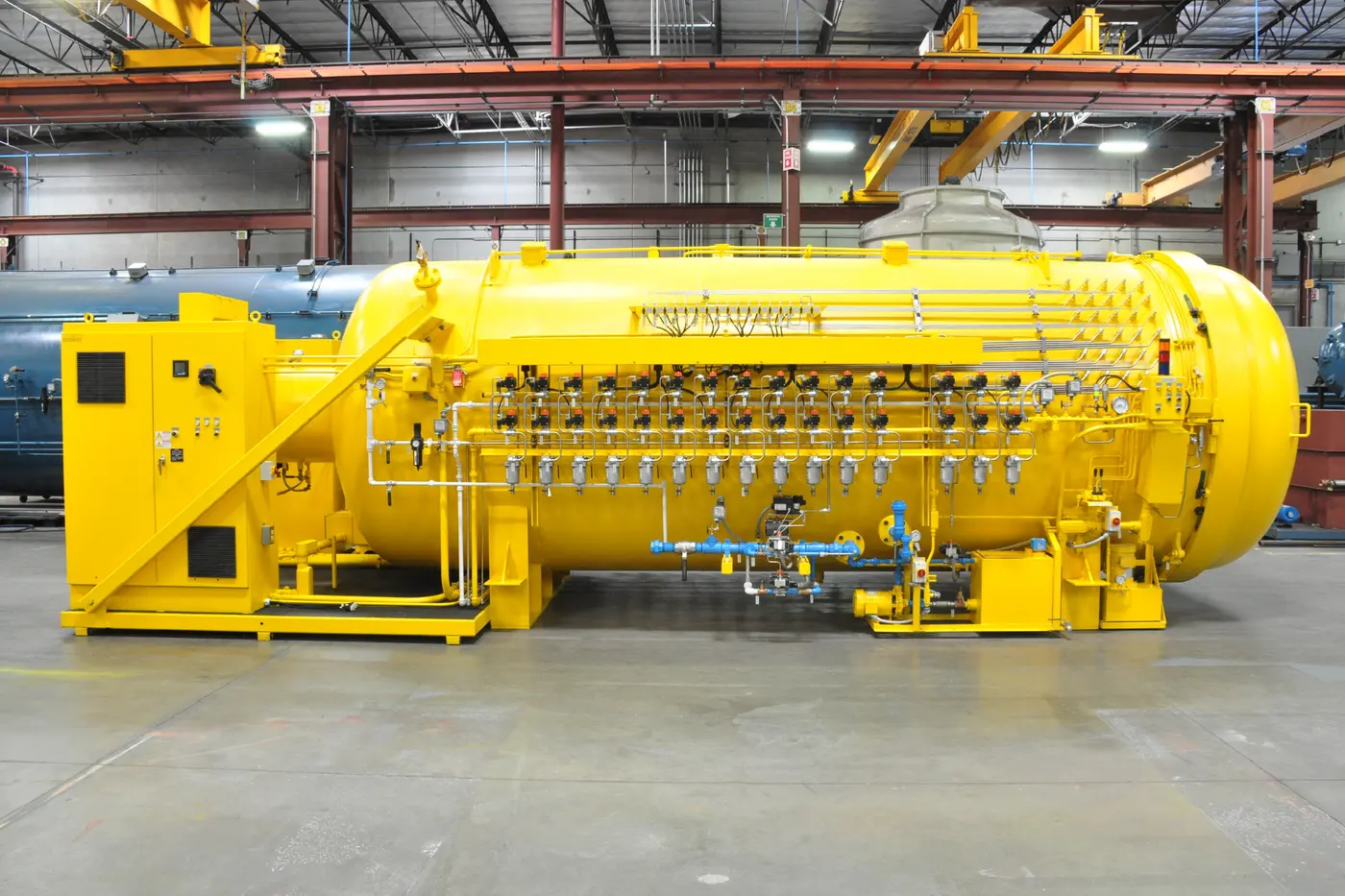 A long yellow ASC autoclave with its vacuum and thermocouple stations along the side