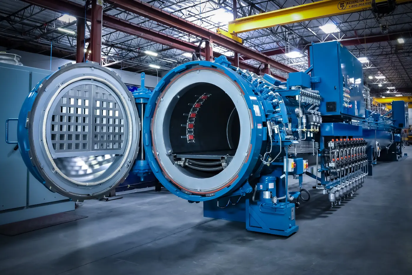 An Econoclave composite curing autoclave with its door open in the ASC shop