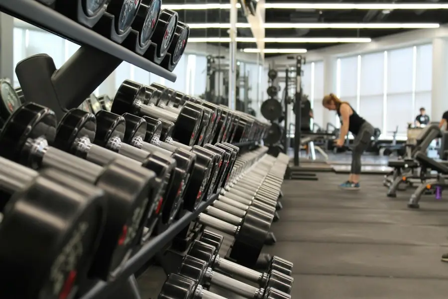 Dumbbell racks in a bright gym