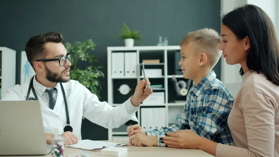 A doctor talking with a boy and his mother