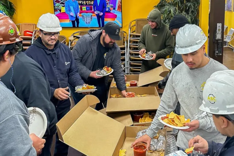 ASC shop crew in hard hats at a safety celebration lunch