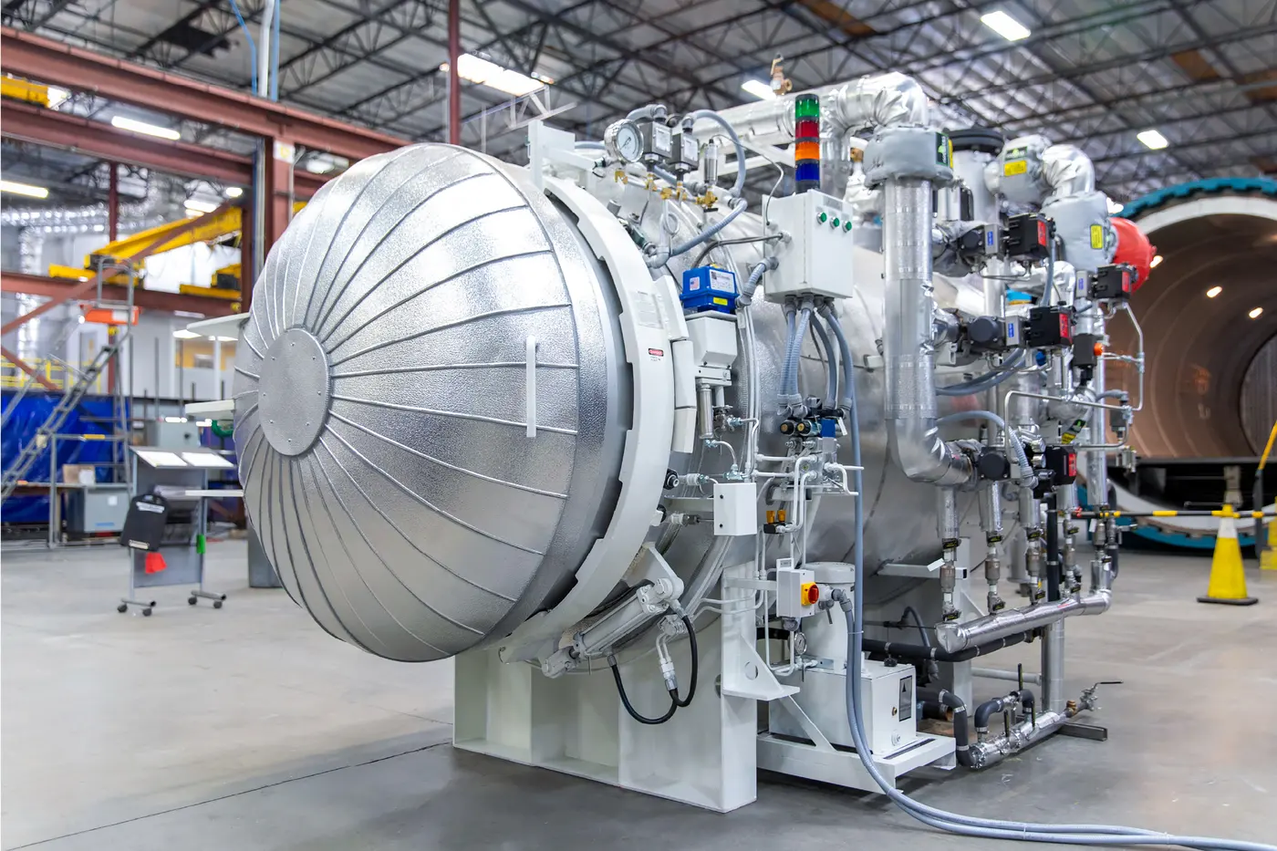 An insulated ASC 4 × 4 ft dewaxing autoclave with its controls and piping