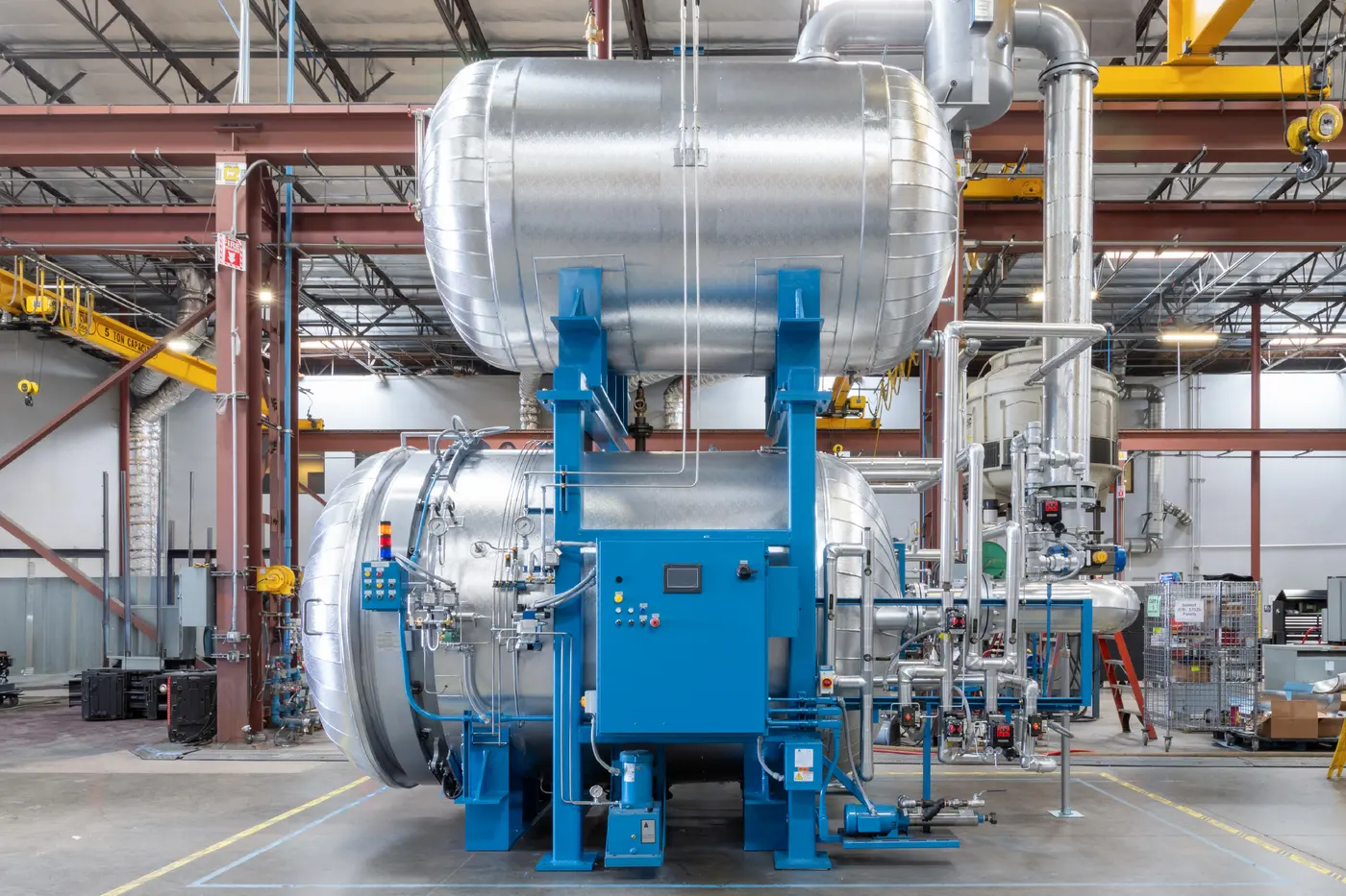 An ASC dewaxing autoclave with its steam accumulator mounted above it