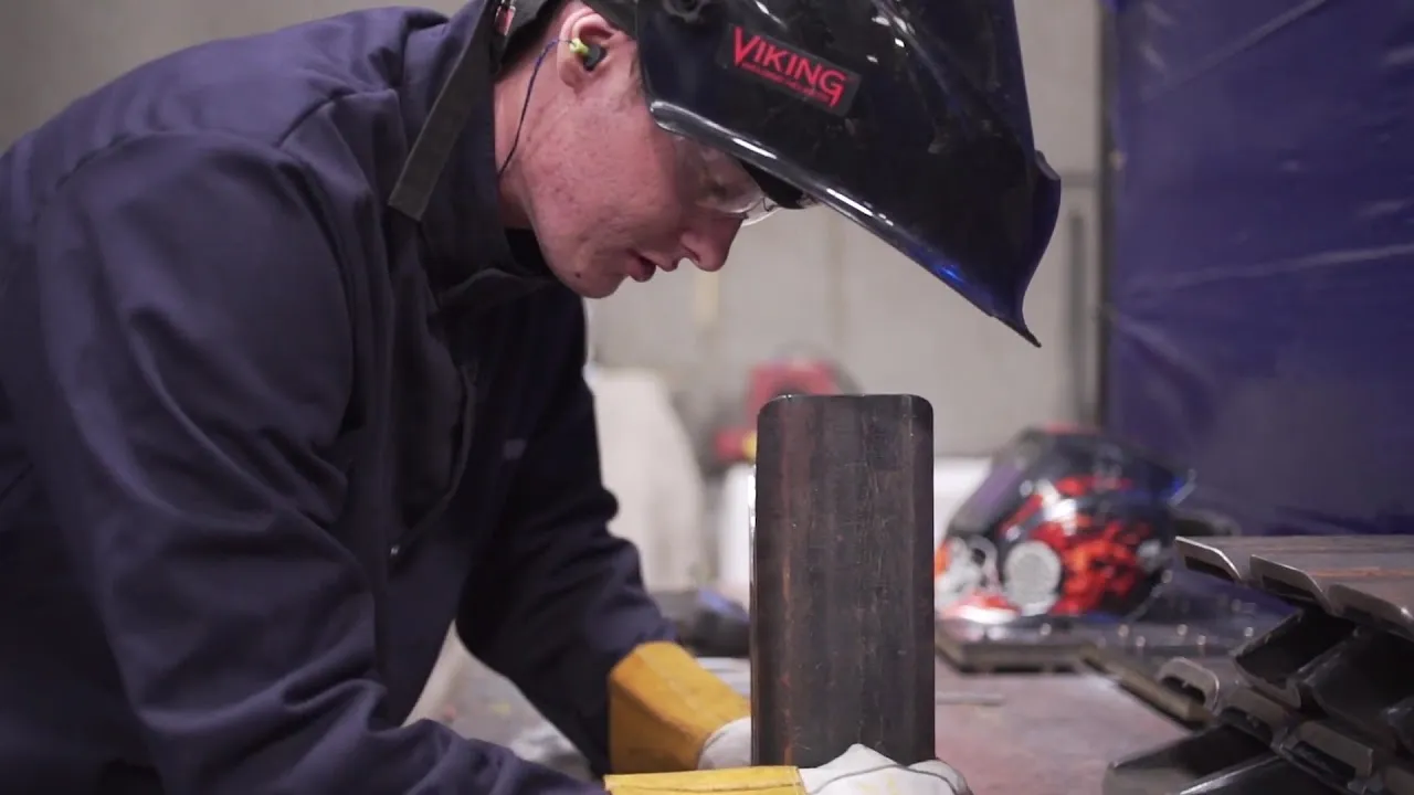 An ASC fabricator welding at the bench