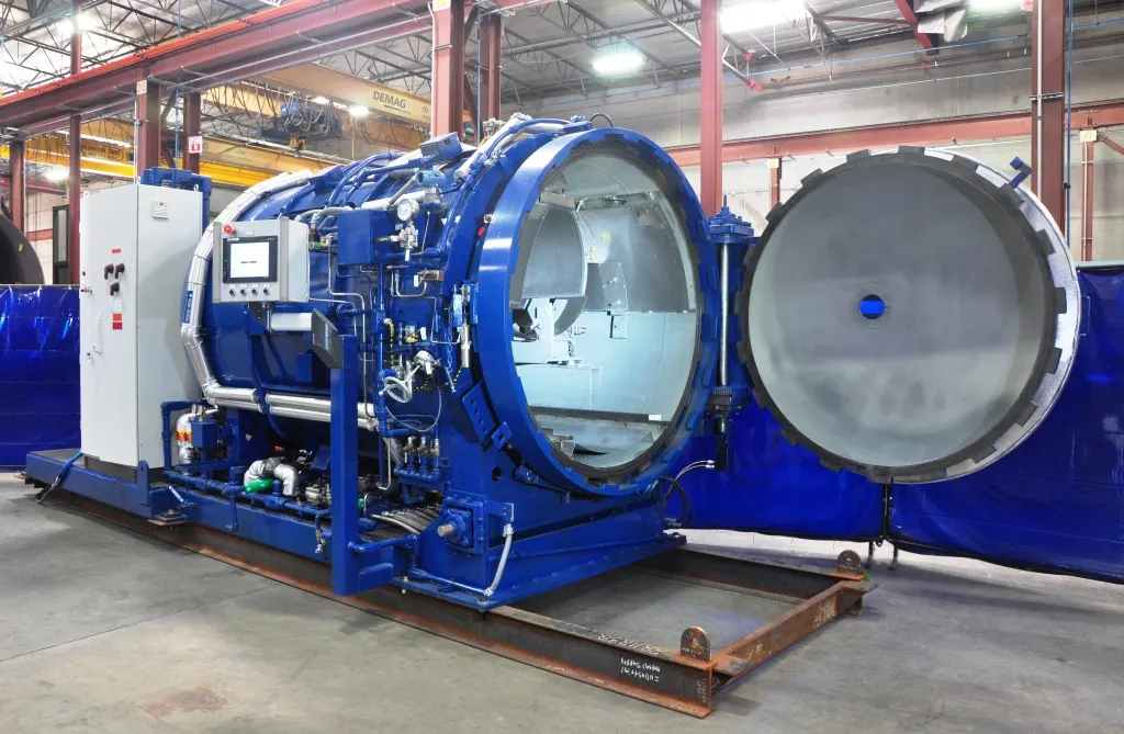 An ASC UF₆ autoclave with its door open, showing the cylinder cradle