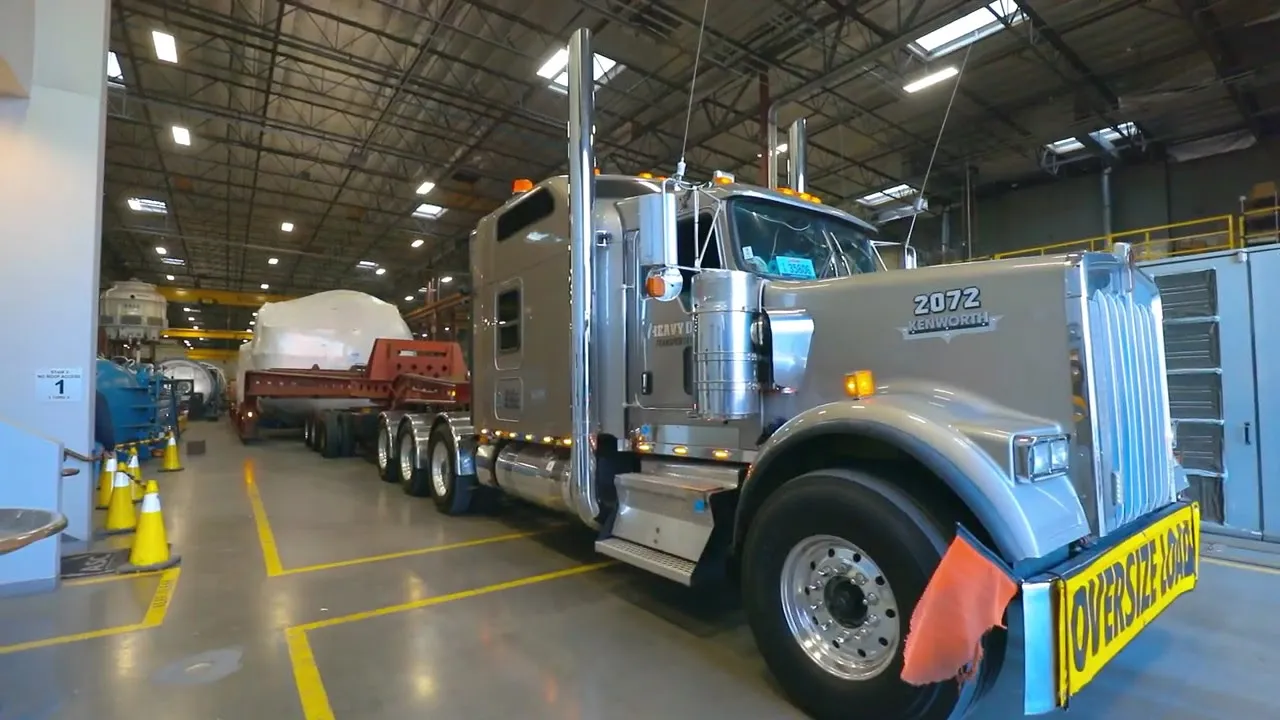 An oversize-load truck hitched to a wrapped ASC vessel inside the Valencia plant
